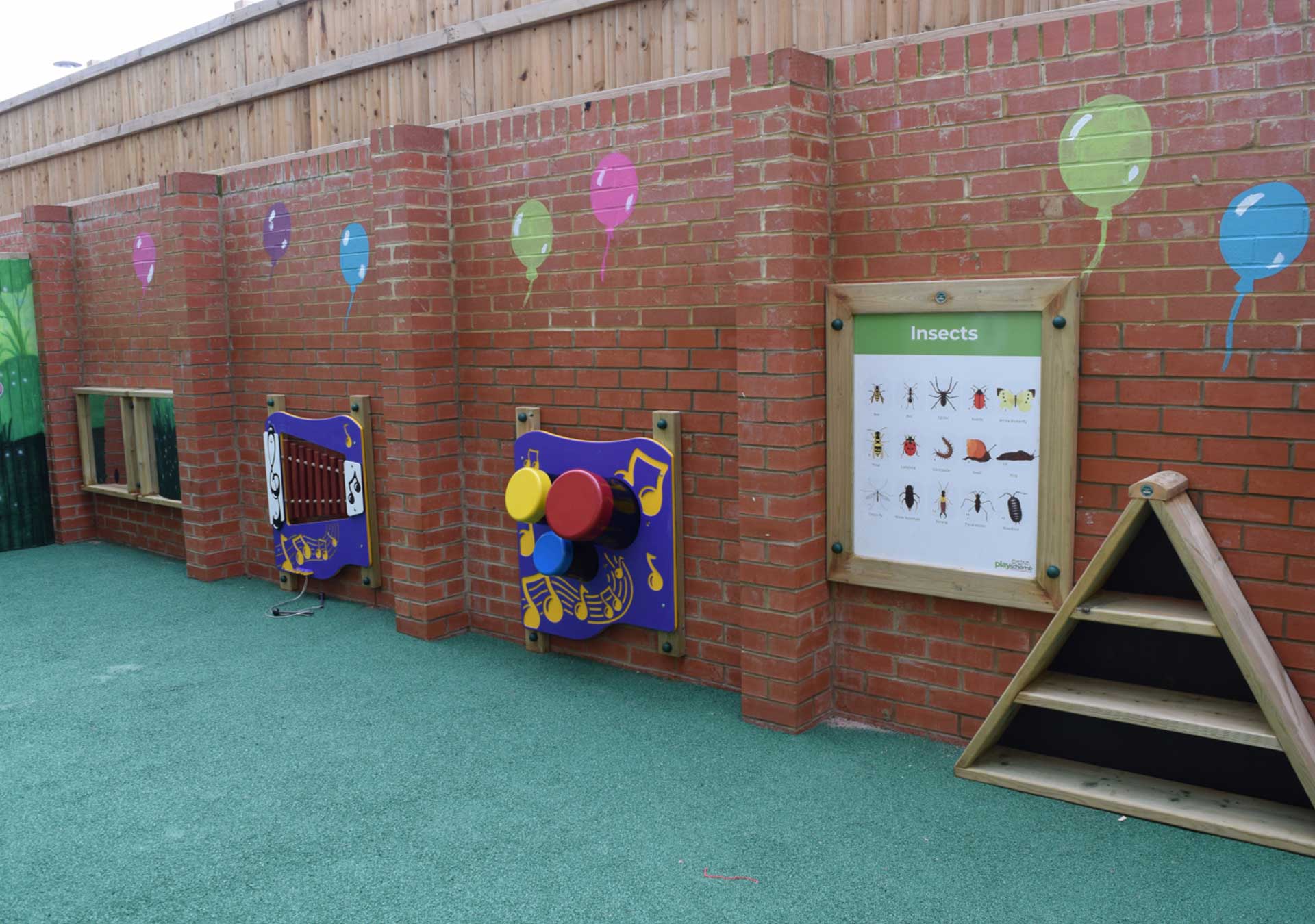 Outdoor play wall with music panels and a picture board