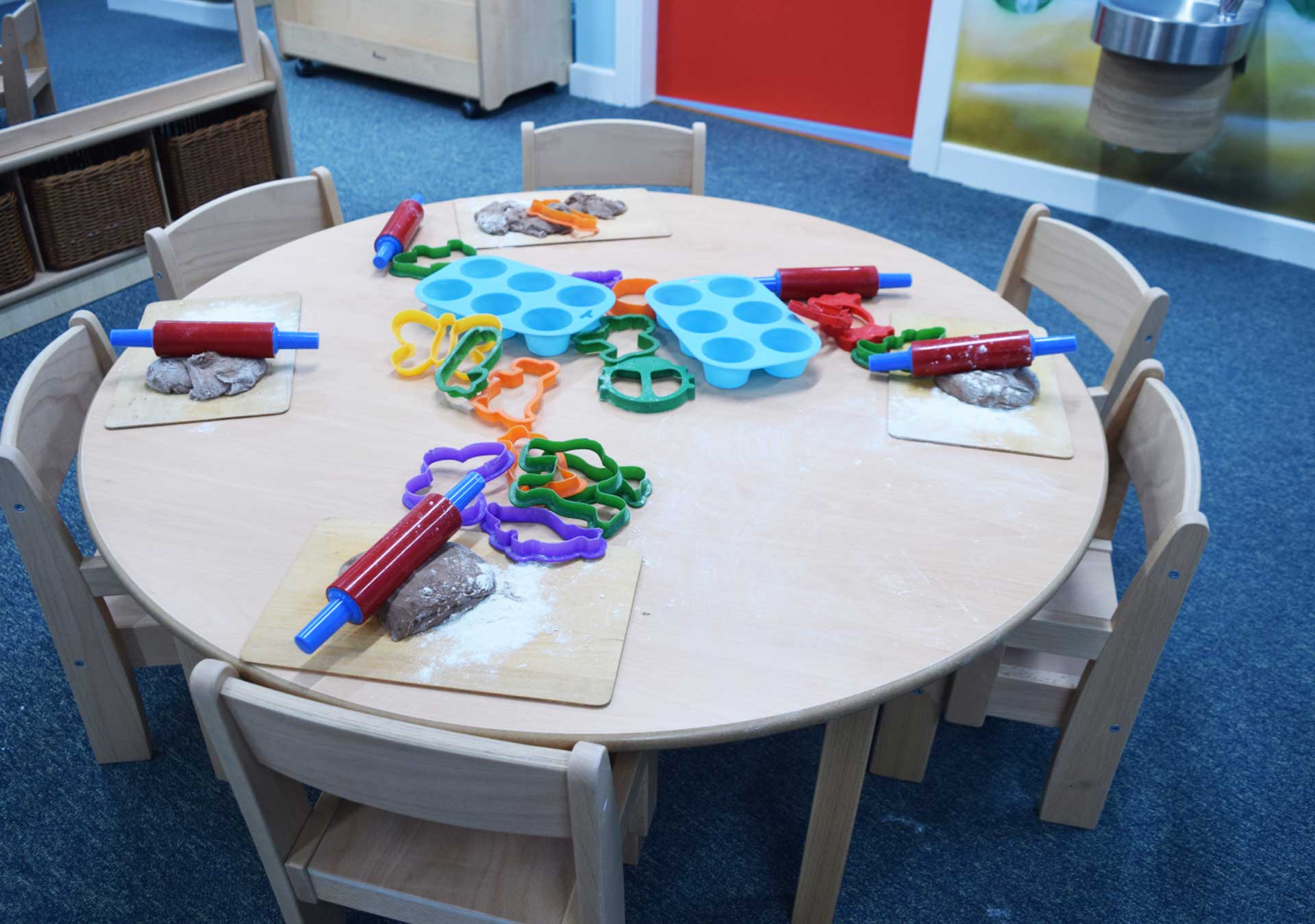 Round table set with play dough, rollers and cutters