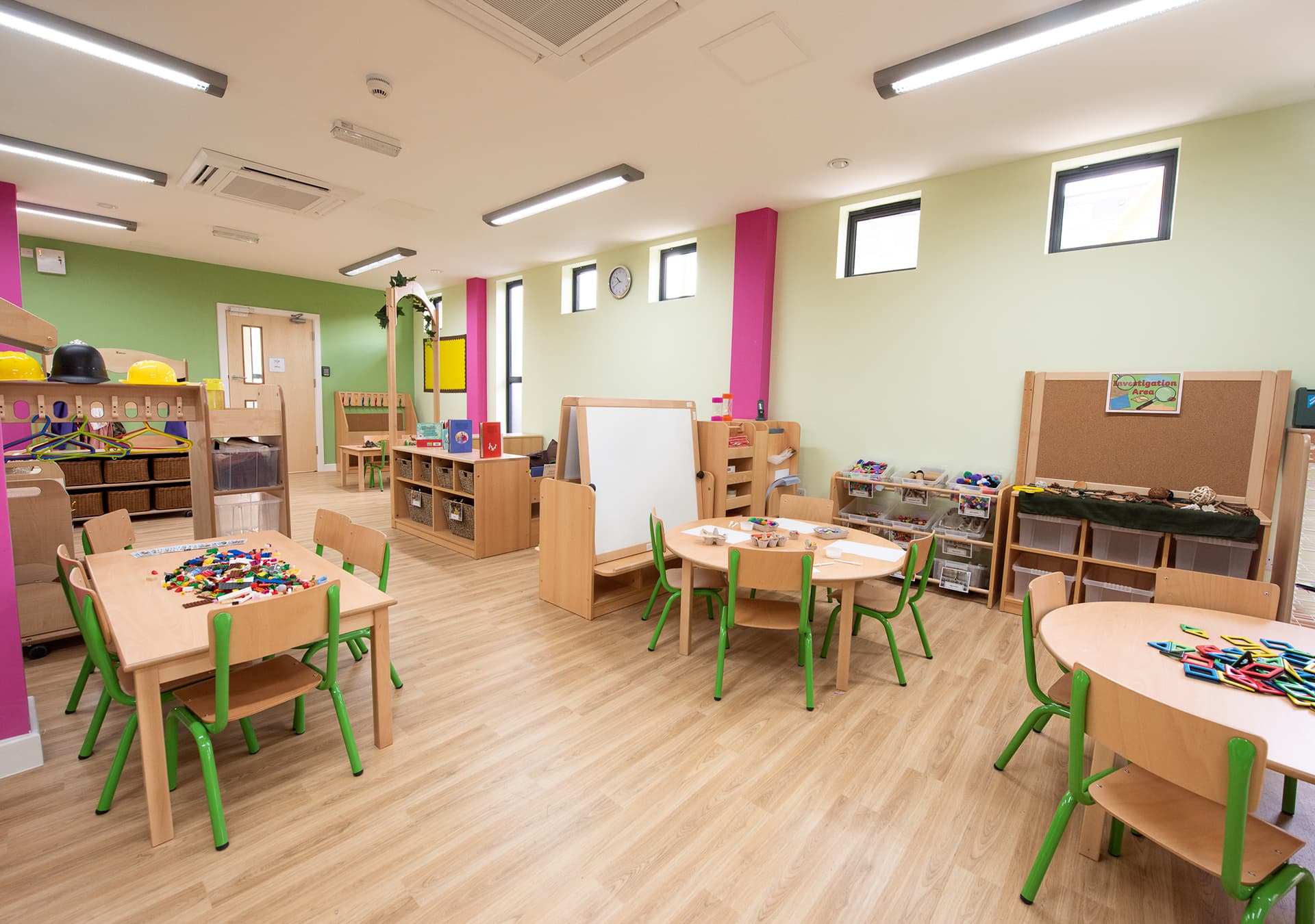 Classroom with small tables and chairs, ready for activities