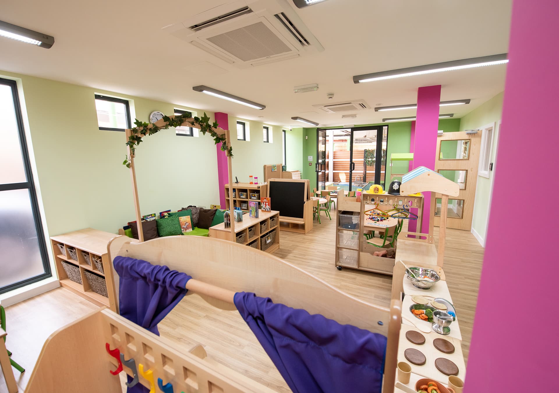 Playroom with a cosy reading nook and role play area