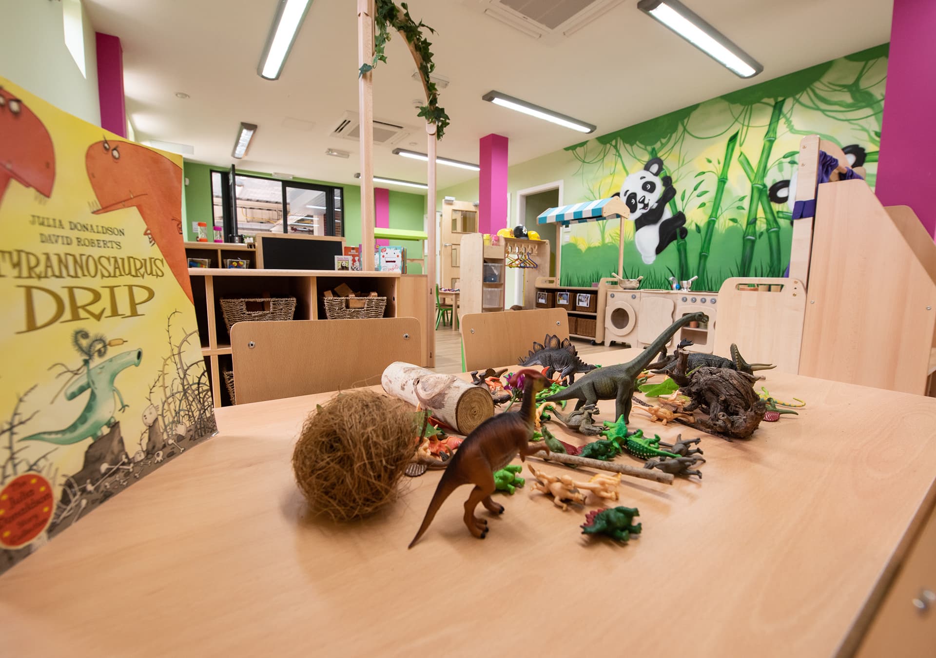 Table set with toy dinosaurs and a story book