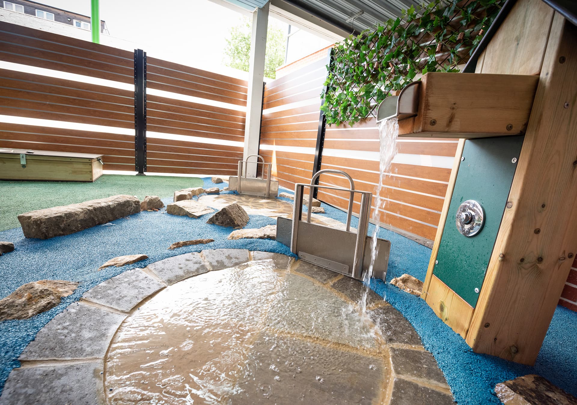 Outdoor water feature with stones and a paved circle