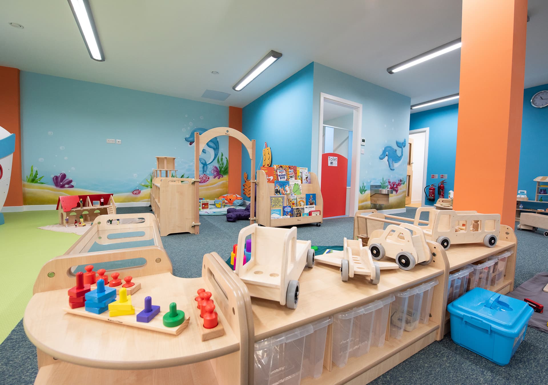 Wooden play furniture with stacking toys and toy cars