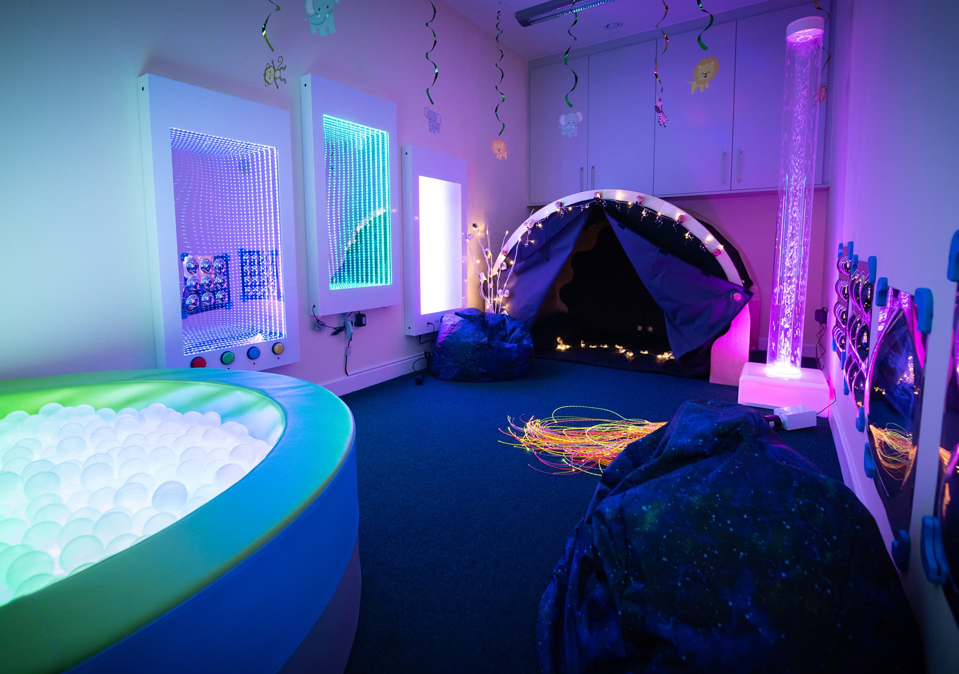 Sensory room with a light-up ball pit, bubble tube and sensory tent