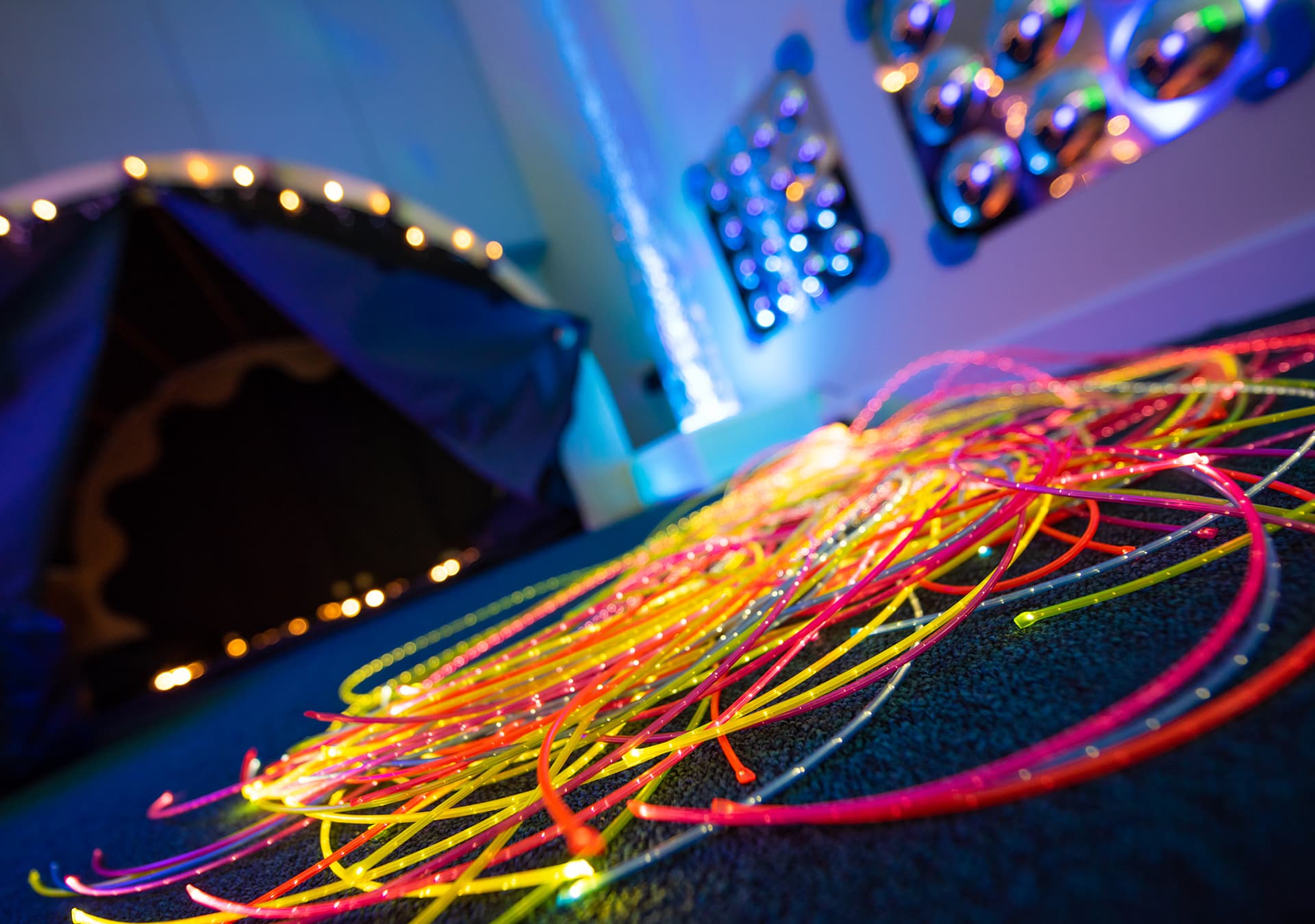 Close-up of glowing fibre optic strands in the sensory room