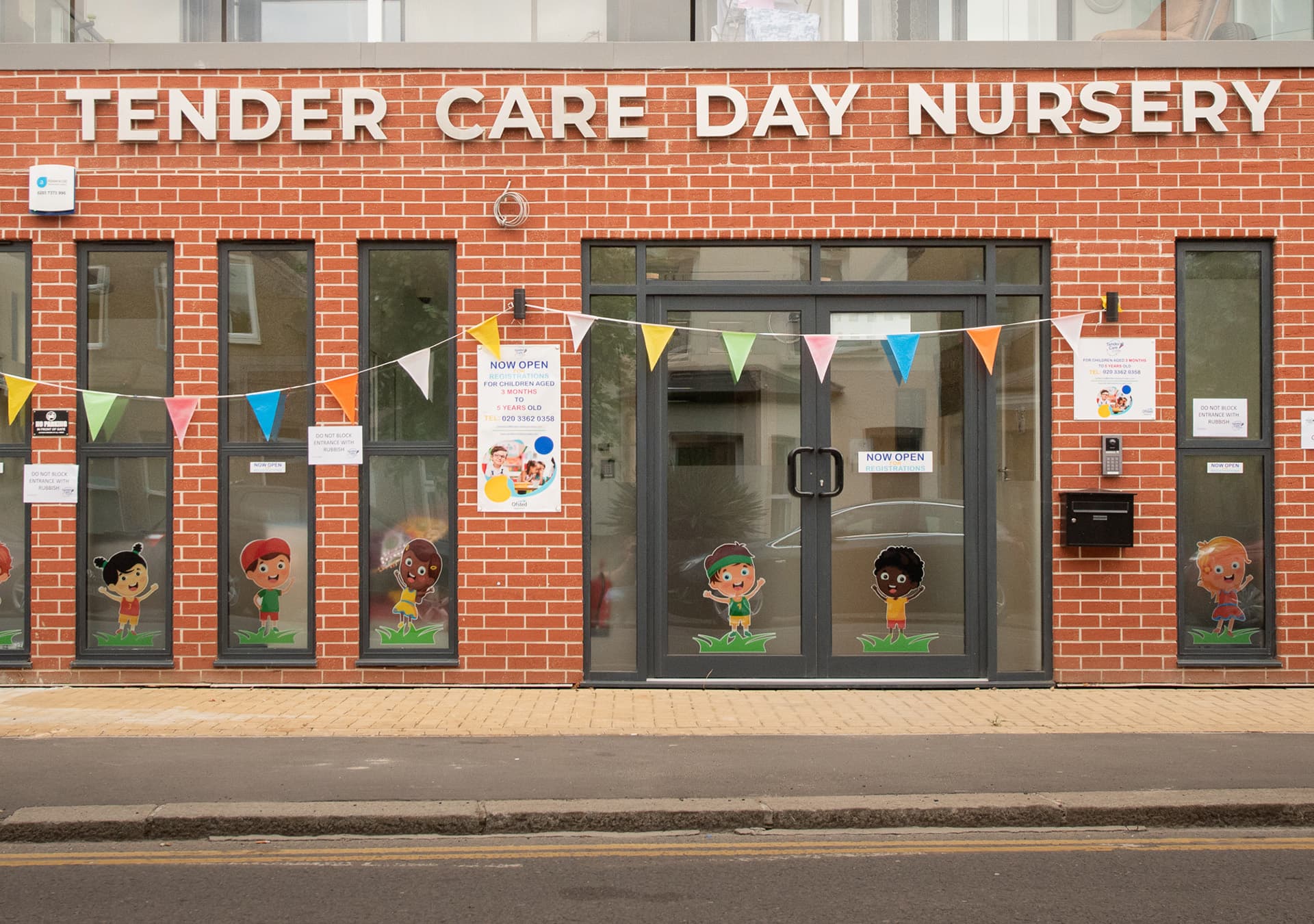 Front of the Tender Care Day Nursery building with bunting